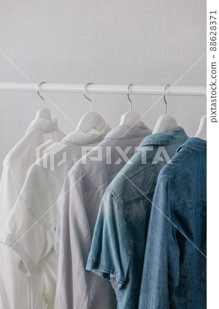 Closet, clothes hanging on hangers, stylish closet selection on a rail in the living room, Closet, clothes hanging on hangers, stylish closet selection on a rail in the living room, 88628371