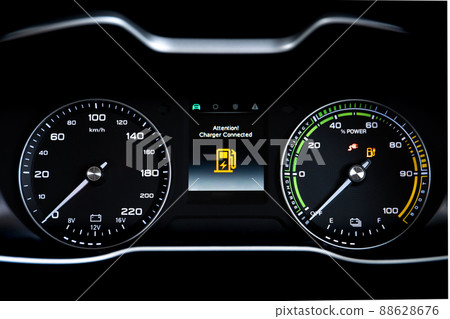 Digital modern dashboard in a electric vehicle - EV while charging at the charging station, battery electric vehicle or BEV. Dashboard in the vehicle showing charging status. Digital modern dashboard in a electric vehicle - EV while charging at the charging station, battery electric vehicle or BEV. Dashboard in the vehicle showing charging status. 88628676