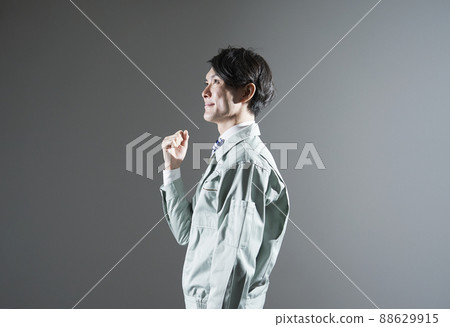Male worker guts pose gray background 88629915