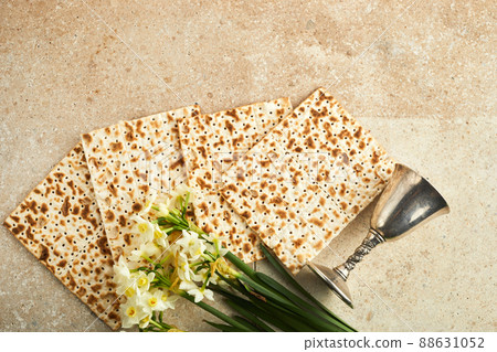 Pesah celebration concept, jewish Passover holiday. Matzah and red kosher. Traditional ritual Jewish bread on travertine stone background Pesah celebration concept, jewish Passover holiday. Matzah and red kosher. Traditional ritual Jewish bread on travertine stone background 88631052