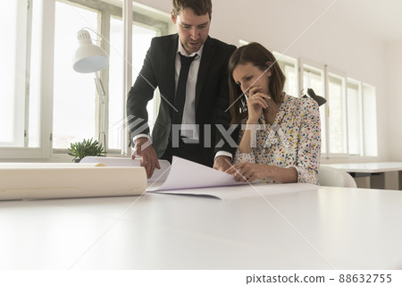 Experienced businessman analyzing blueprints Experienced businessman analyzing blueprints 88632755