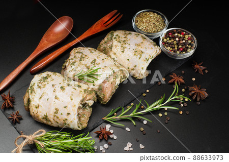 Raw marinated chicken thighs in a light sauce with herbs and spices on a dark background with herbs. Chicken half-cooked thighs. Top of view. Raw chicken marinated. Raw marinated chicken thighs in a light sauce with herbs and spices on a dark background with herbs. Chicken half-cooked thighs. Top of view. Raw chicken marinated. 88633973
