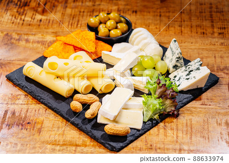 Various types of cheese with empty space background.Set or assortment cheeses. Top view. Assortment of different cheese types on wooden table. Cheese background. Various types of cheese with empty space background.Set or assortment cheeses. Top view. Assortment of different cheese types on wooden table. Cheese background. 88633974