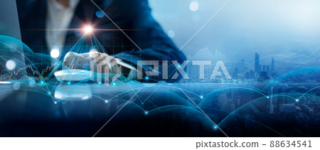 Businessman using laptop and analyzing customer data on economic growth graph chart and management global structure networking with customer data exchanges. Investment and digital marketing network. 88634541