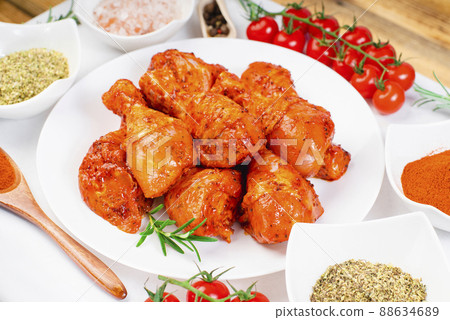 Cooking chicken drumsticks.Raw chicken legs in a marinade with rosemary and pepper.Top view.Hot grilled chicken leg.Raw chicken legs. Delicious marinated chicken legs . Cooking chicken drumsticks.Raw chicken legs in a marinade with rosemary and pepper.Top view.Hot grilled chicken leg.Raw chicken legs. Delicious marinated chicken legs . 88634689