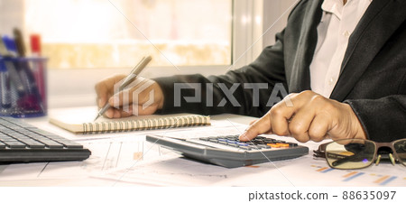 Businesswoman checking accounts and finances to calculate invoices in the office. Audit concept. 88635097