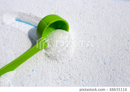 Detergent powder with measuring spoon for clothes washing. Laundry concept. Detergent powder with measuring spoon for clothes washing. Laundry concept. 88635118