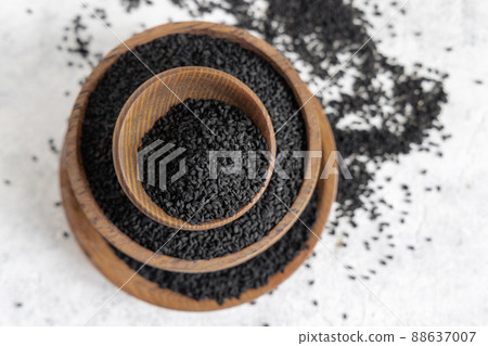 Indian spice Black cumin (nigella sativa or kalonji) seeds in wooden bowls top view 88637007
