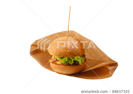 Delicious and juicy hamburger in recyclable craft brownpaper Delicious and juicy hamburger in recyclable craft brownpaper 88637101