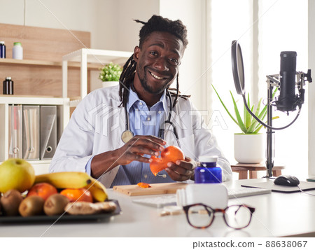 young nutritionist take a break in office and eat a tangerine young nutritionist take a break in office and eat a tangerine 88638067
