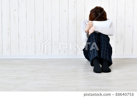 A woman crying with her face on the cushion A woman crying with her face on the cushion 88640758