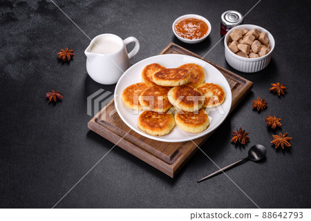 Cottage cheese pancakes with oats, syrniki on a black rustic background 88642793