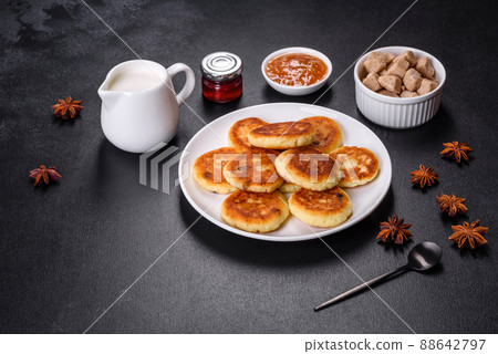Cottage cheese pancakes with oats, syrniki on a black rustic background Cottage cheese pancakes with oats, syrniki on a black rustic background 88642797