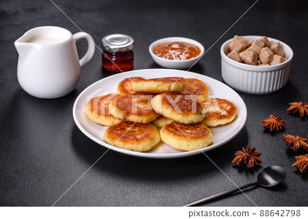 Cottage cheese pancakes with oats, syrniki on a black rustic background Cottage cheese pancakes with oats, syrniki on a black rustic background 88642798