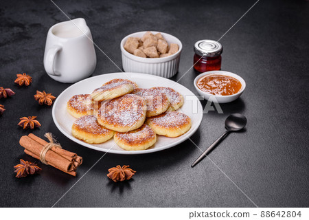Cottage cheese pancakes with oats, syrniki on a black rustic background 88642804