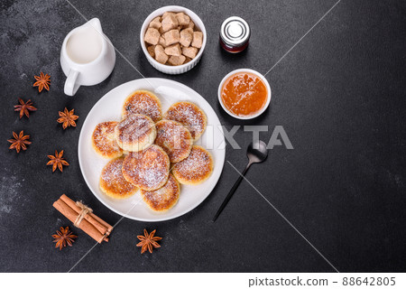Cottage cheese pancakes with oats, syrniki on a black rustic background 88642805