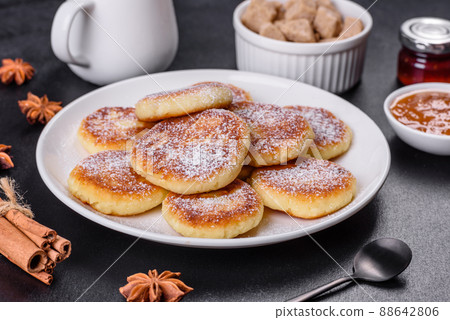 Cottage cheese pancakes with oats, syrniki on a black rustic background 88642806