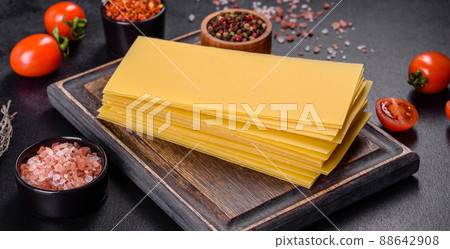 Stack of lasagna sheets on a dark concrete background. Ingredients for lasagna 88642908