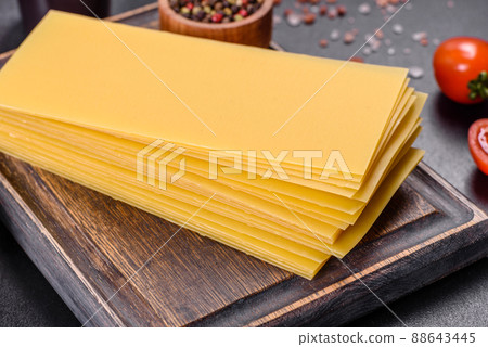 Stack of lasagna sheets on a dark concrete background. Ingredients for lasagna Stack of lasagna sheets on a dark concrete background. Ingredients for lasagna 88643445