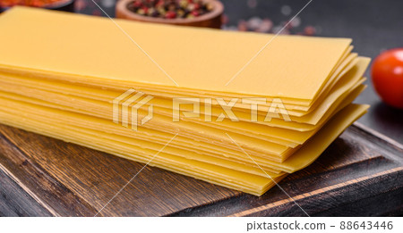 Stack of lasagna sheets on a dark concrete background. Ingredients for lasagna 88643446