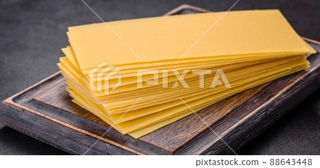 Stack of lasagna sheets on a dark concrete background. Ingredients for lasagna 88643448