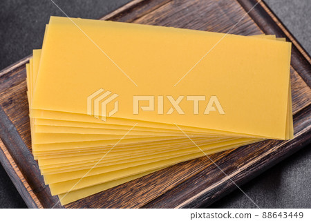 Stack of lasagna sheets on a dark concrete background. Ingredients for lasagna Stack of lasagna sheets on a dark concrete background. Ingredients for lasagna 88643449