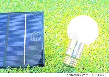 Lawn, solar panels and shining light bulbs 88643779