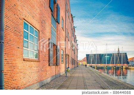 Old brick house on the embankment of the canal leading to the Five Circles Pedestrian Bridge. Copenhagen, Denmark 88644088