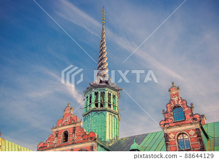 Tower with spire on the roof of the Old Stock Exchange Borsen Topped with four entwined dragon tails. Copenhagen, Denmark 88644129