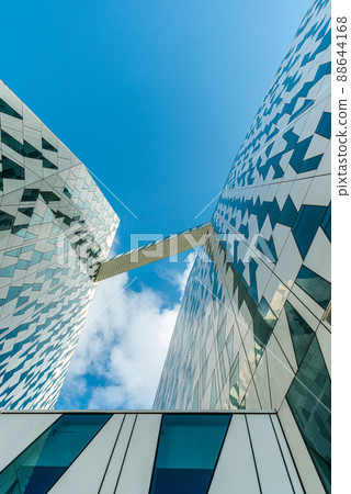 Bottom view of a white glass modern building AC Hotel Bella Sky in city area orestad. Copenhagen, Denmark 88644168