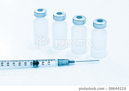 Vial of Drugs and 1 ml Plastic Syringe with Needle Isolated on the White Background Vial of Drugs and 1 ml Plastic Syringe with Needle Isolated on the White Background 88644229