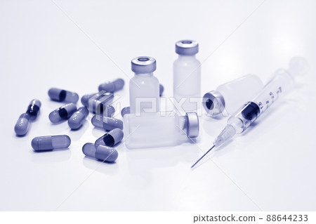 Vial of Drug, 3 ml Plastic Syringe with Needle and Drug Capsules Isolated on the White Background Vial of Drug, 3 ml Plastic Syringe with Needle and Drug Capsules Isolated on the White Background 88644233