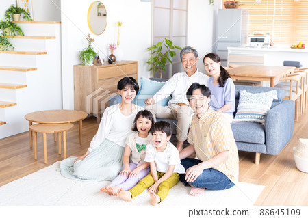 A three-generation family relaxing in the living room A three-generation family relaxing in the living room 88645109