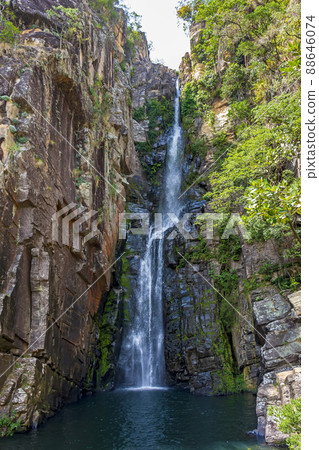 Beautiful waterfall called Veu da Noiva between moss covered rocks and the vegetation 88646074