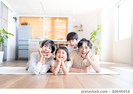 A family of four lying down in the living room A family of four lying down in the living room 88646958