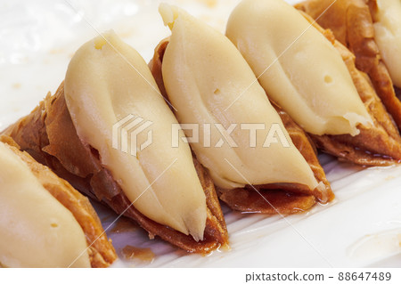 Greek dessert Trigona Panoramatos - crispy phyllo triangle pastries with custard. 88647489