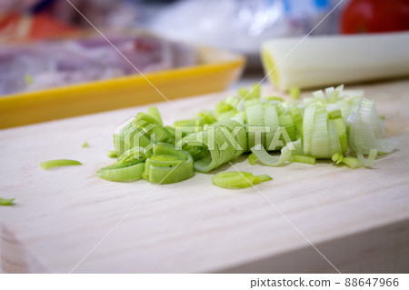 Sliced leek on a wooden cutting board Sliced leek on a wooden cutting board 88647966