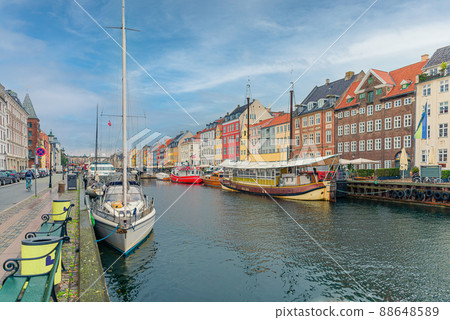 Many old boats, yachts and ships stand along the Nyhavn canal and colorful houses. Copenhagen, Denmark Many old boats, yachts and ships stand along the Nyhavn canal and colorful houses. Copenhagen, Denmark 88648589