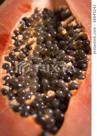 Half of an open papaya with the seeds Half of an open papaya with the seeds 88649242