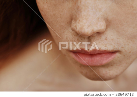 Close-up of young female face with freckles and ginger hair 88649718