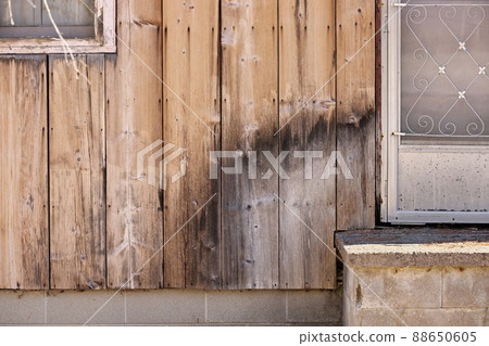 Close up of Weathered Wood Siding Beginning to Rot Around Front Step of Cottage or House Close up of Weathered Wood Siding Beginning to Rot Around Front Step of Cottage or House 88650605