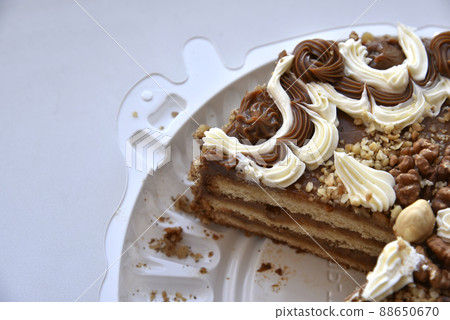 Black cake with nuts on a backing Black cake with nuts on a backing 88650670