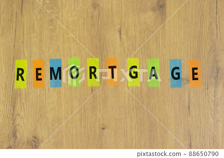 Remortgage success symbol. The concept word Remortgage on colored papers on a beautiful wooden background. Business and remortgage success concept, copy space. 88650790