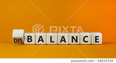 Balance or disbalance symbol. Turned cubes and changed the word disbalance to balance. Beautiful orange background, copy space. Business, balance or disbalance concept. 88650794