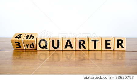 From 3rd third to 4th forth quarter symbol. Turned wooden cubes and changed words 3rd quarter to 4th quarter. Beautiful wooden table white background. Business happy 4th quarter concept. Copy space. 88650797