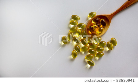 Wooden spoon with pills isolated on beautiful white background. Web banner with a copy space. 88650941