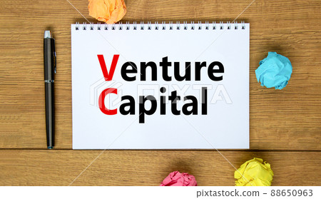 VC venture capital abbraviation symbol. Concept words VC venture capital on white note. Metallic pen. Beautiful wooden background. Copy space. Business and VC venture capital concept. 88650963