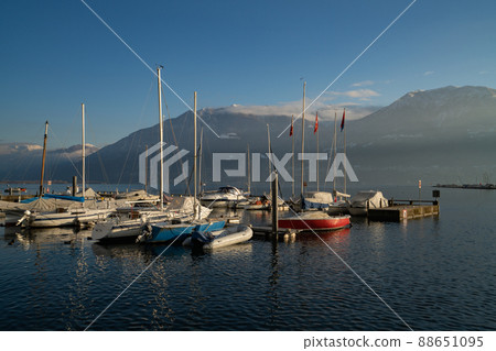 Winter landscape of lake Maggiore with boats in Locarno, Switzerland Winter landscape of lake Maggiore with boats in Locarno, Switzerland 88651095