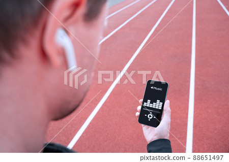 Fitness training music. Man choose music for running. Lifestyle workout exercise woman training. Fitness, sport, lifestyle concept. 88651497