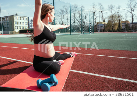 Pregnancy training. Pregnant woman training yoga sport exercise. Prenatal healthy fitness active fit gym outside. Prenatal exercises. Pregnancy training. Pregnant woman training yoga sport exercise. Prenatal healthy fitness active fit gym outside. Prenatal exercises. 88651501